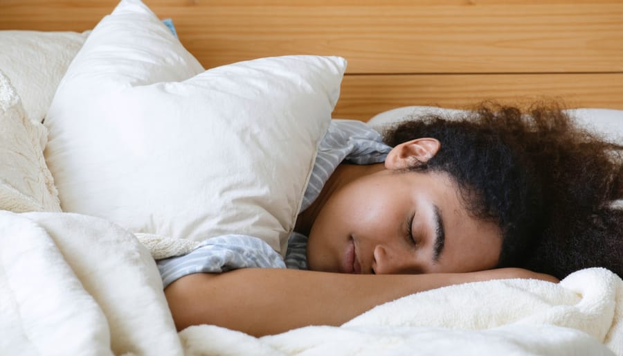 Person enjoying restful sleep in a comfortable bed